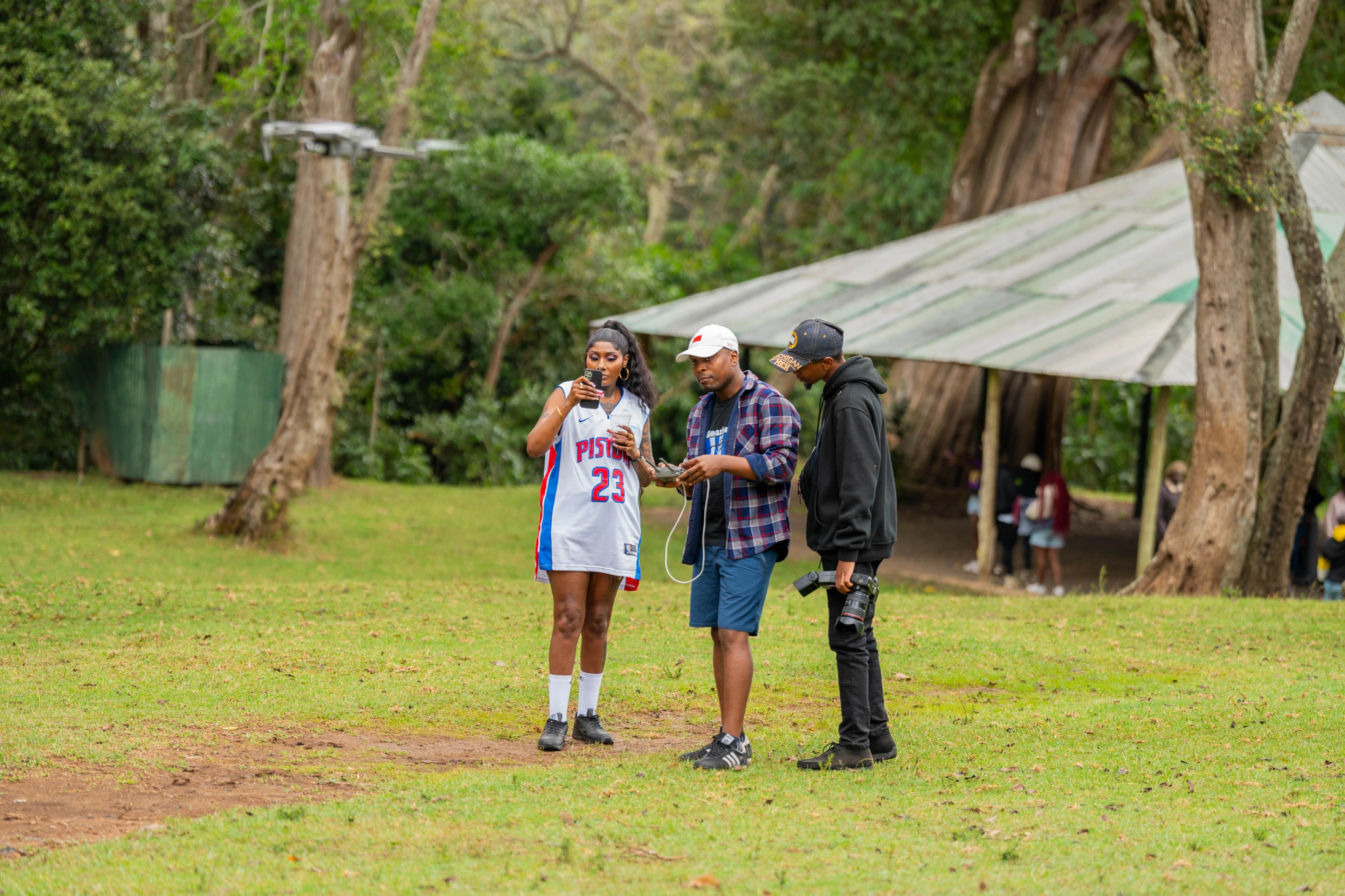 Cinematic photograph of a young couple laughing during a golden hour outdoor shoot, shallow depth of field, warm tones, professional DSLR style.